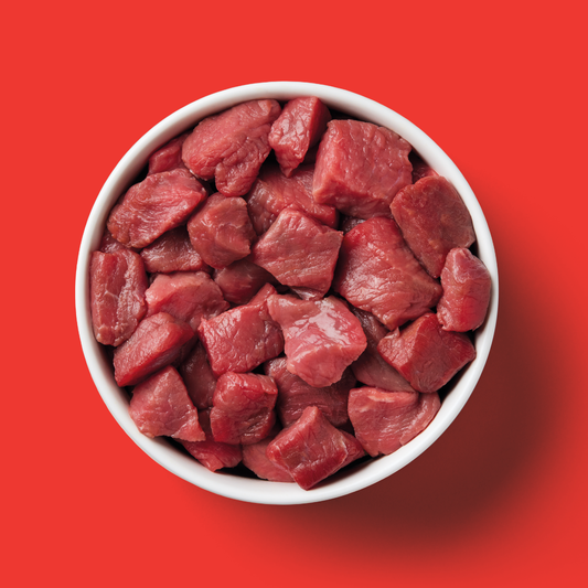 A 5kg Cat Raw Starter Duo Box with raw beef cubes sits on a bright red background.