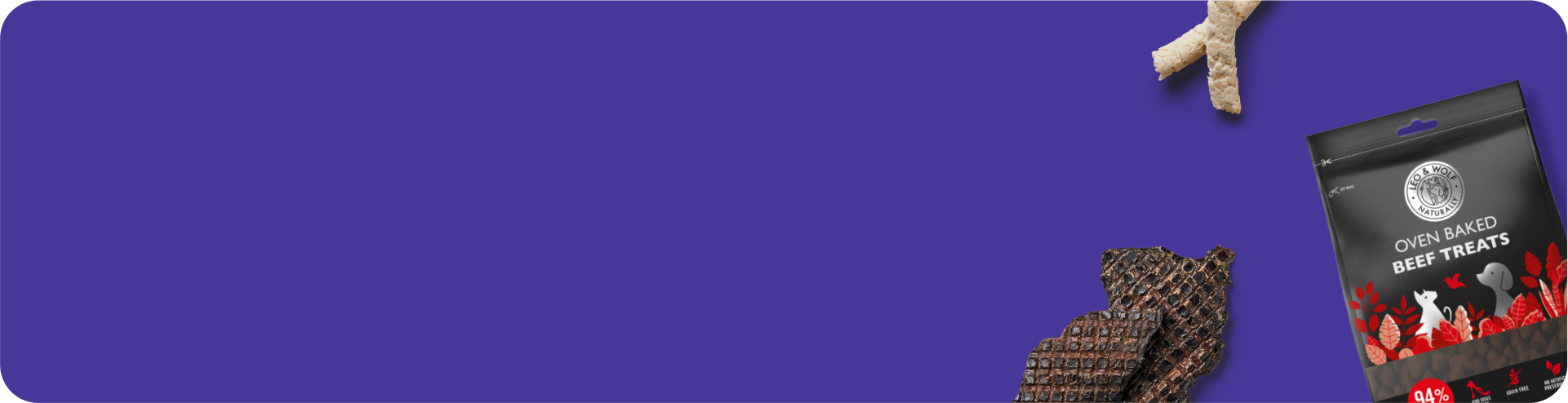 A purple background with a bag of oven-baked beef treats, two dog treats, and a piece of beef jerky scattered on the right side.