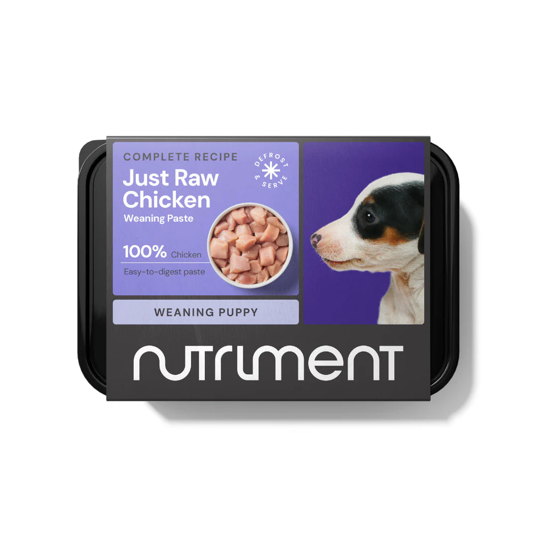 Tray of Nutriment Just Raw Chicken Weaning Paste for puppies, featuring chunks of chicken and a puppy image on label.