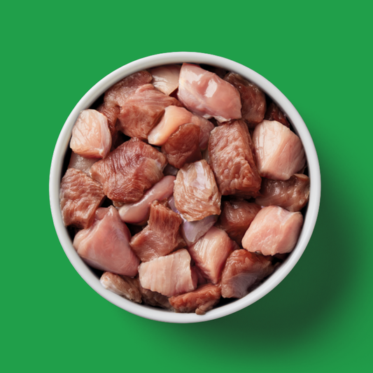 A white bowl of Cat Raw 3 Bird Roast 500g (Christmas Limited Edition) on a solid green background.