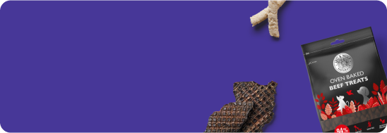 Dog treats and packaging against a purple background.