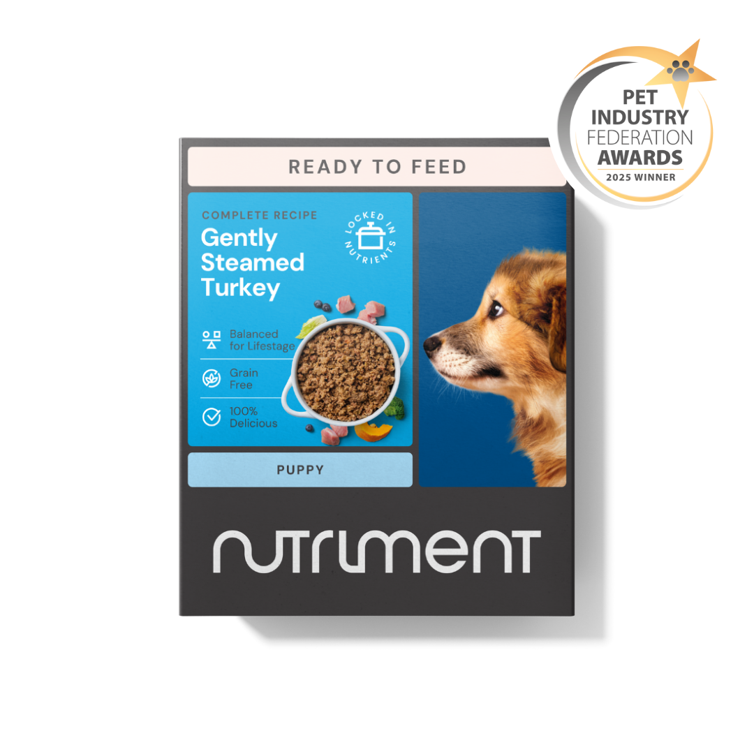 Box of Nutriment Puppy Gently Steamed Turkey 395g with dog image and awards badge.