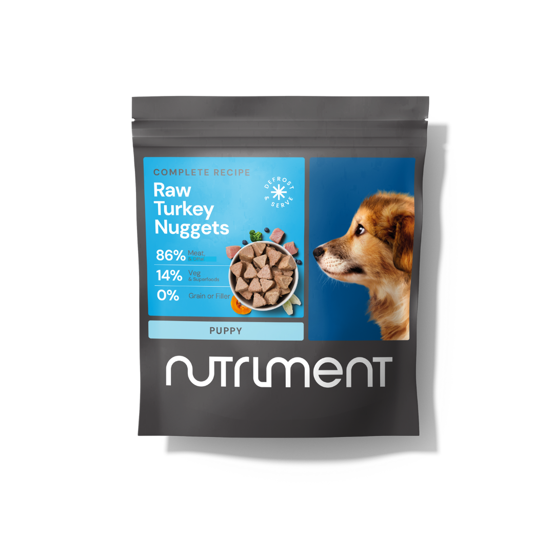 A puppy food bag labeled "Raw Beef Nuggets 1kg" featuring fresh meat nuggets and a playful puppy.
