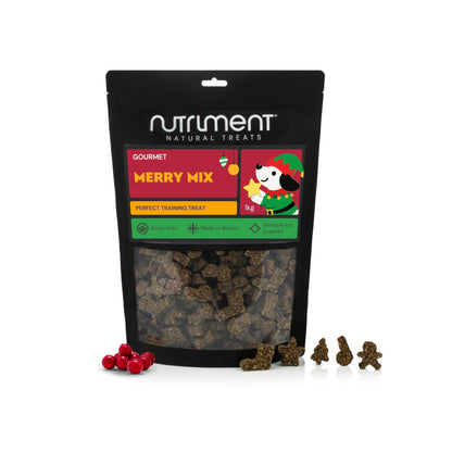 A bag of Gourmet Merry Mix 150g grain-free dog treats with a window showing star, tree, and gingerbread-shaped biscuits.